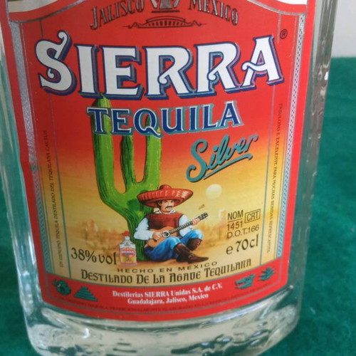 Sierra vintage tequila used, opened bottle with cap damage