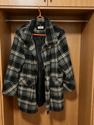 Checked coat with high collar, pockets and buttons