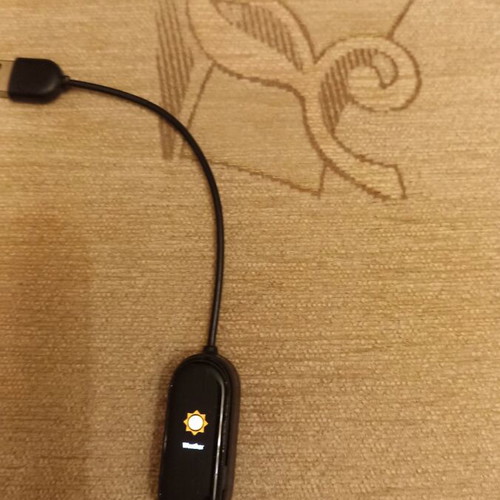 Mi Band smart watch used with charger, strap needs replacement