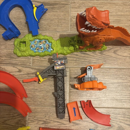 Hot Wheels track set pieces with T-Rex figure and launcher