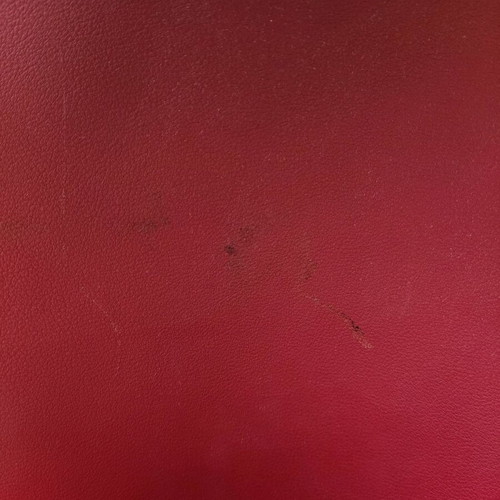 Red backpack used with broken zipper and mark