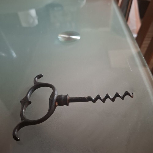 Old metal corkscrew bottle opener with handmade ring handle