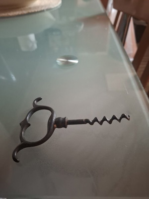 Old metal corkscrew bottle opener with handmade ring handle