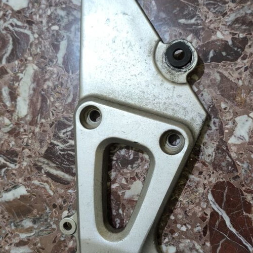 Suzuki XF 650 Freewind left passenger footrest bracket used, damaged