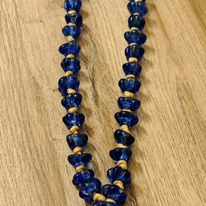Tabletop komboloi with blue and gold glass beads