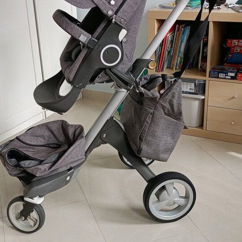 Stokke Xplory stroller used with mosquito net and rain cover