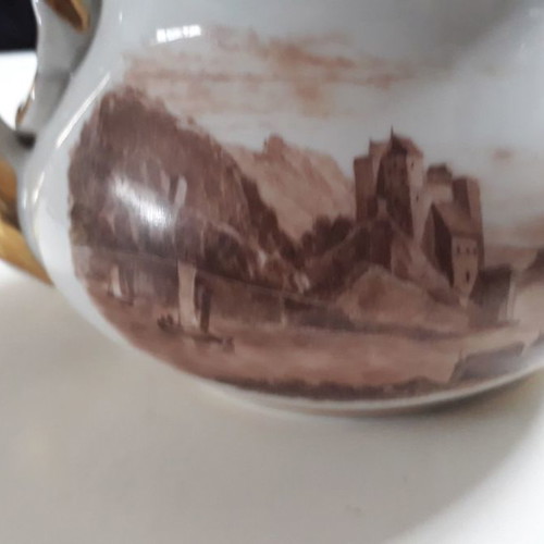Antique porcelain teapot with wooden handle used