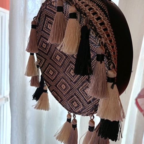 Round crossbody bag black like new, with tassels
