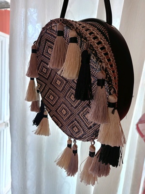 Round crossbody bag black like new, with tassels