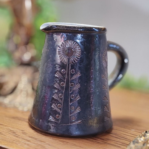 Retro ceramic milk jug with embossed flowers