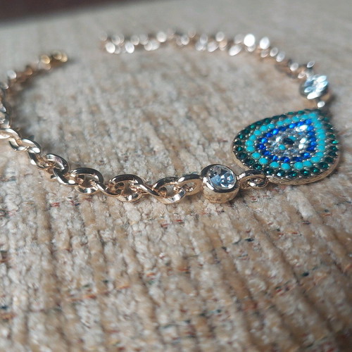 Gold bracelet new with eye and blue, turquoise, white stones
