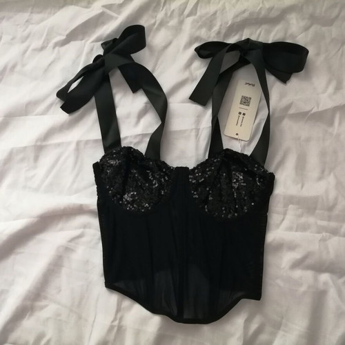 Women's black bustier corset top with sequins and sheer waist