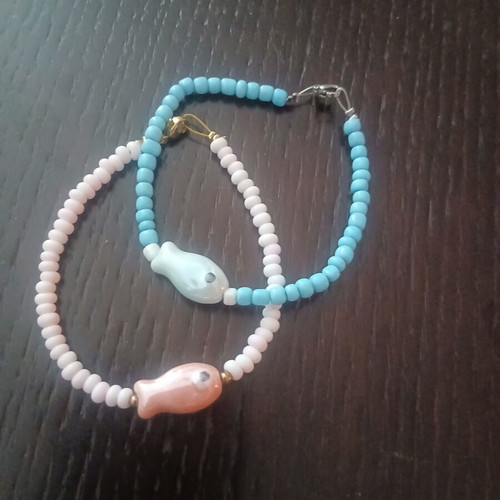 Two handmade island-style bracelets with beads and stone fish