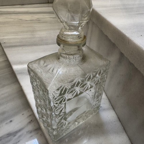 Glass liquor bottle used with embossed design