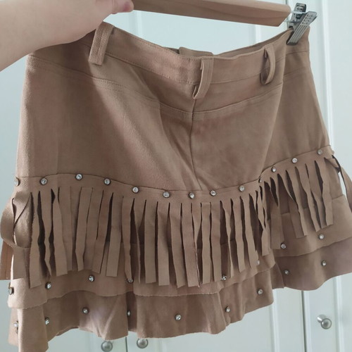 Skirt used with suede-type fringes and matte antique gold details