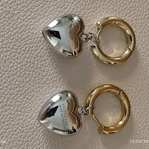Balenciaga earrings with two tone dangling hearts like new