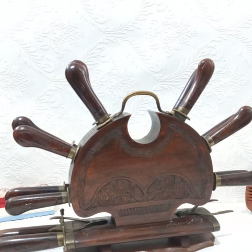 Wooden carved stand with used set of knives and forks