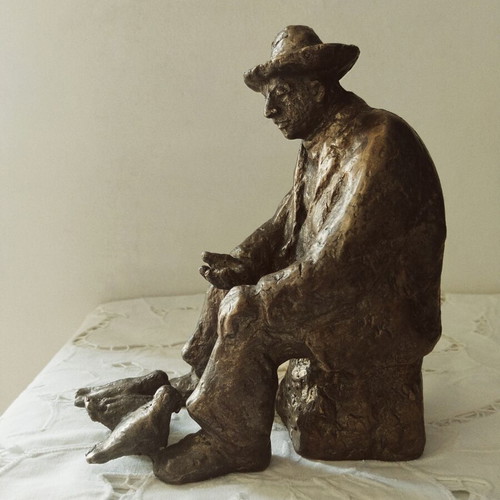Realistic sculpture of an elderly man feeding pigeons, new