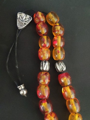Komboloi with silver details used, amber beads