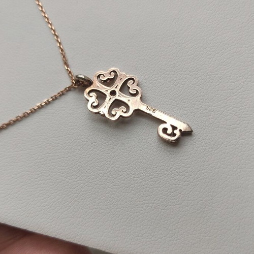 Silver gold-plated key-shaped pendant like new