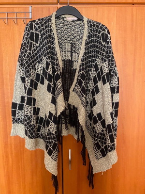 Knitted women's cardigan used, black-gold, asymmetrical with fringes