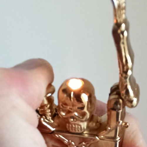 Vintage metal windproof lighter with skull and crossed rifles