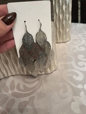 Silver dangling earrings with leaf design used