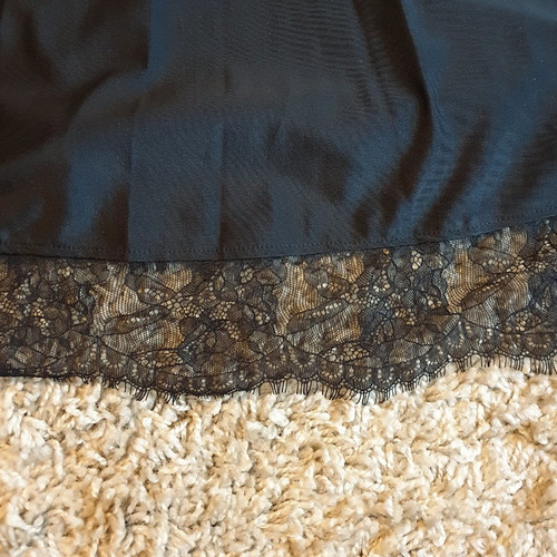 Black crossover dress used with delicate lace trim