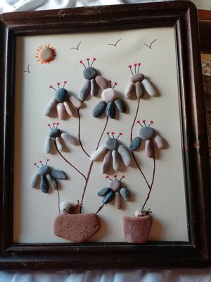 Wooden wall art with pebble flower design in vintage frame