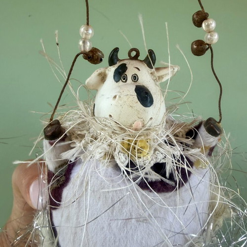Hanging decorative ornament with fabric and ceramic cow