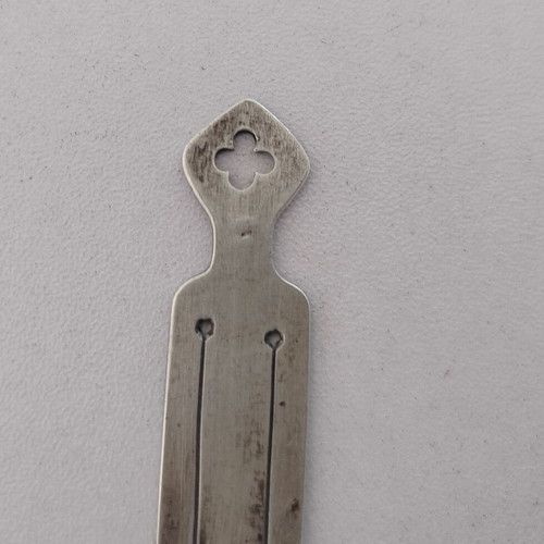 Silver bookmark with cross-shaped handle, used