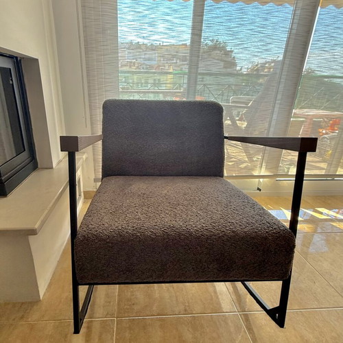 Rocking armchair with grey boucle fabric