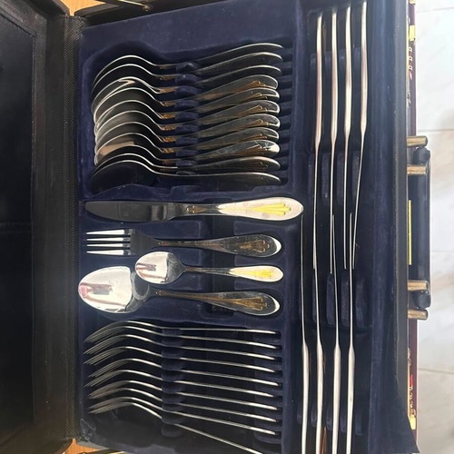 Cutlery set like new with knives, forks, spoons, and kitchen accessories