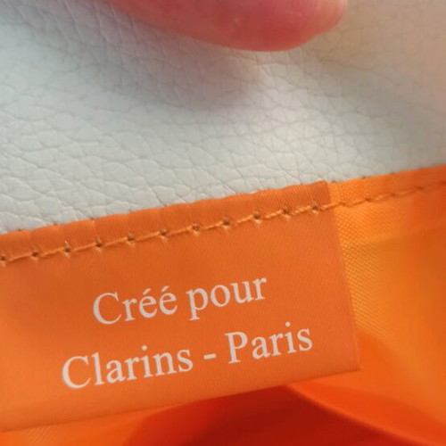 Clarins cosmetic bag new, white with striped handles
