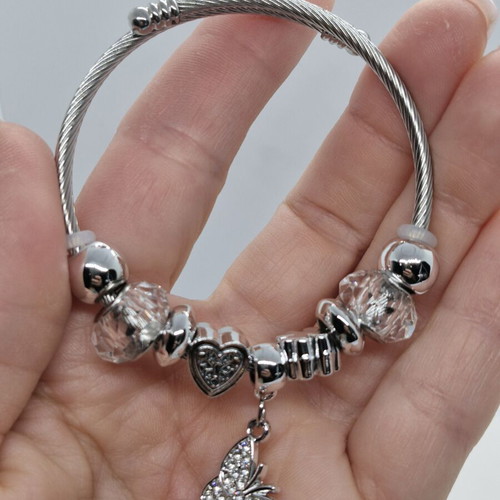 Stainless steel open bracelet with butterfly charm and zirconia
