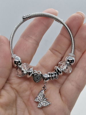 Stainless steel open bracelet with butterfly charm and zirconia