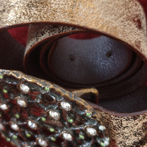 Wide gold belt used with decorative buckle and rhinestones