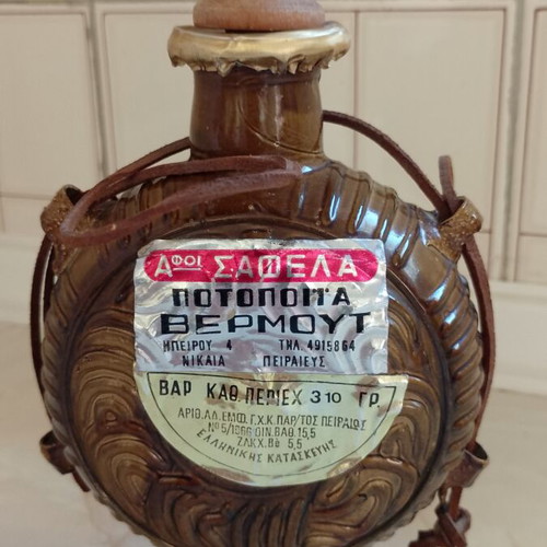 Vintage souvenir vermouth bottle with leather strap and wooden stopper like new