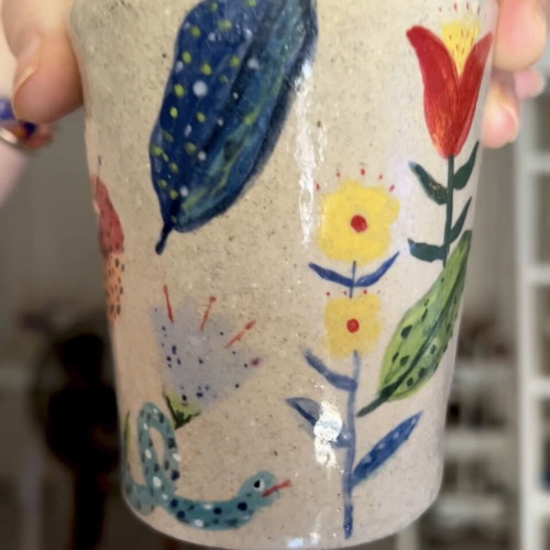 Illustrative ceramic mug handmade with floral design