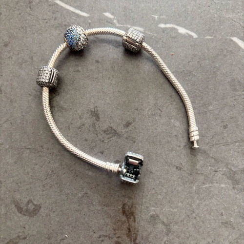 Pandora silver bracelet new with 4 charms and zirconia