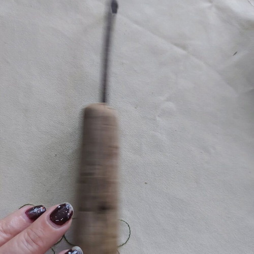 Vintage tool used, wooden part damaged, likely screwdriver