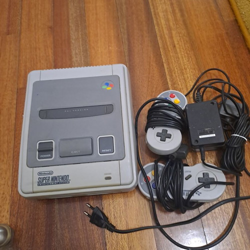 Super Nintendo Entertainment System console with 9 games