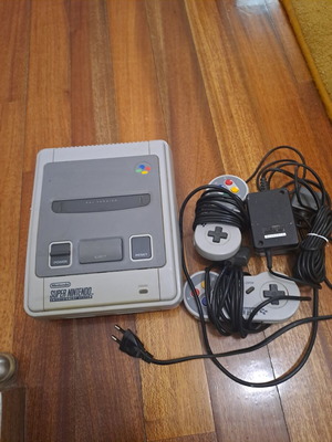 Super Nintendo Entertainment System console with 9 games
