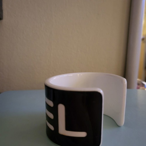 Cuff bracelet like new, black resin with white letters