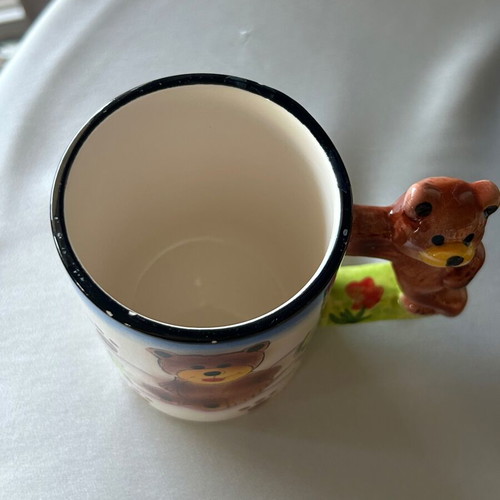 Vintage children's ceramic mug used with embossed designs