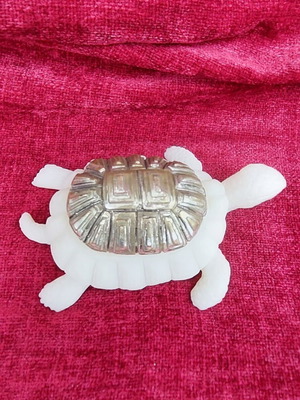 Decorative turtle used with silver-plated metal back