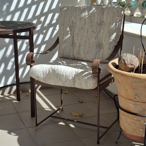 Retro wrought iron garden armchair with cushions used
