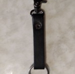 Men's leather keychain used with engraved phrase I will be back