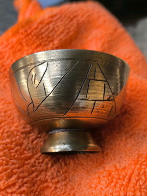 Small bronze container used with engraved decorative surface