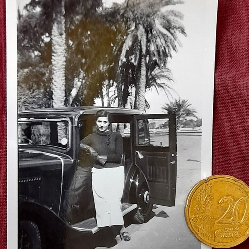 Vintage photo woman with classic prewar car and palms, 1930s